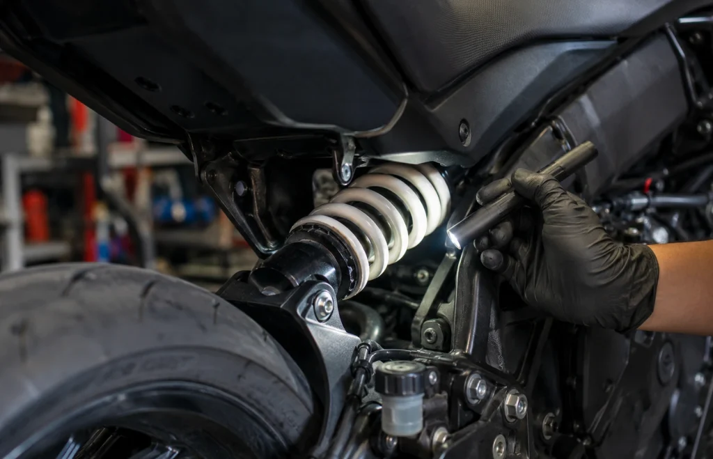 Dettaglio del monoammortizzatore moto durante un controllo visivo